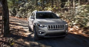 Grey 2019 Jeep Cherokee on a forest lane