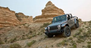 2020 Jeep Gladiator in gray off-roading on a rocky ground