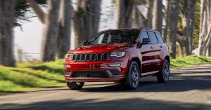 2020 Jeep Grand Cherokee in red driving down the road