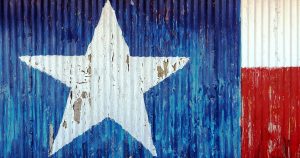 The Texas flag painted on the side of a metal building