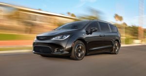 Black 2020 Chrysler Pacifica driving down a road