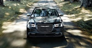 2020 Chrysler 300 in black driving down a shaded road